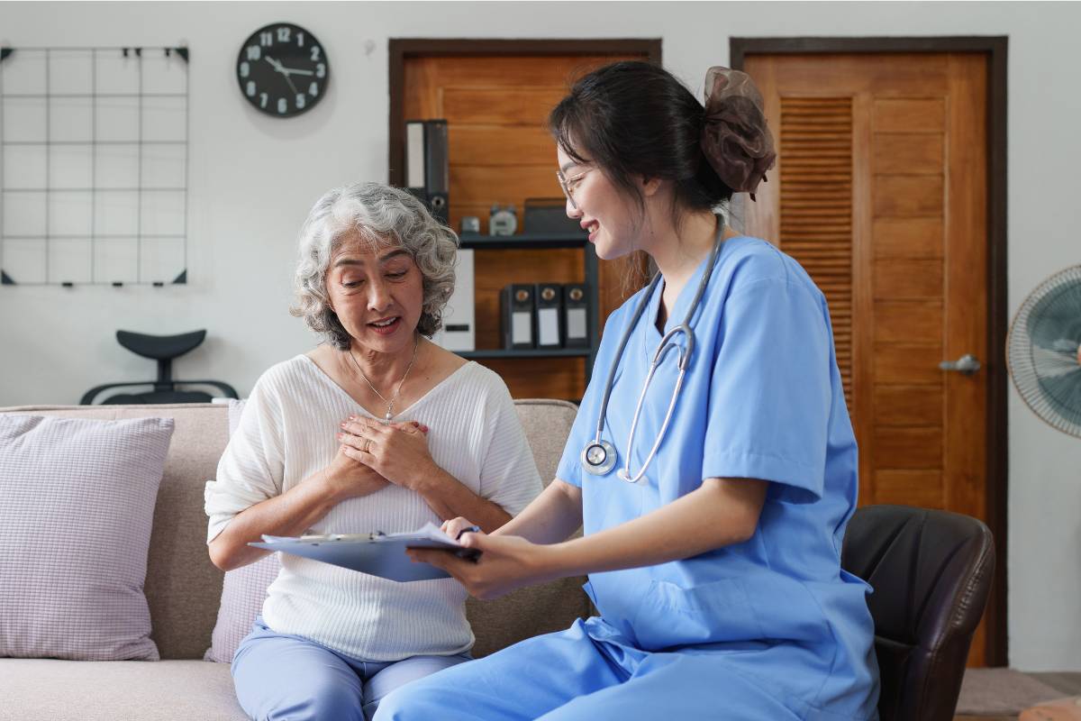 A nurse reviewing care plans with a senior client at home